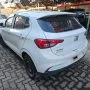 Argo branco estacionado em pátio automotivo.